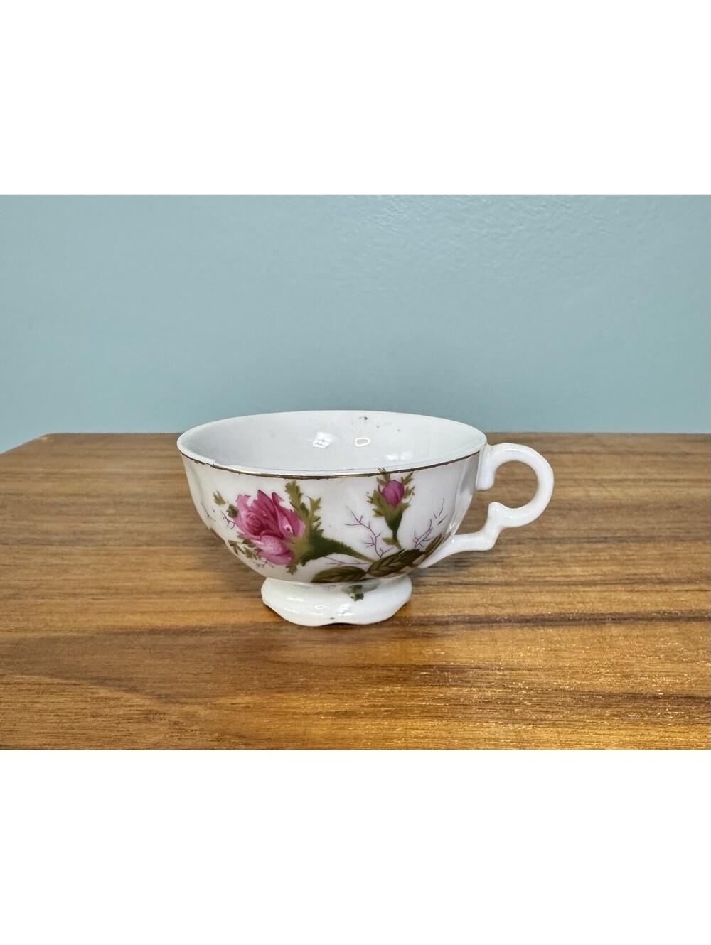 Japanese footed teacup features the "Moss Rose" patter